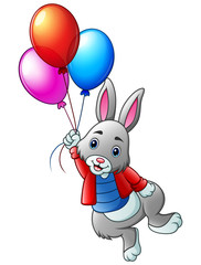Cute rabbit flying with balloons on a white background