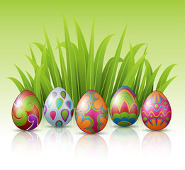 Decorated Easter eggs with green grass background