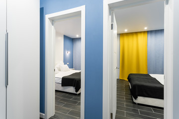 Fototapeta na wymiar inexpensive family room. Hotel standart two bedroom. simple and stylish interior. interior lighting