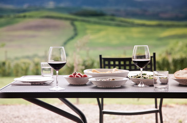 lunch with a view - table against beautiful landscape in Tuscany
