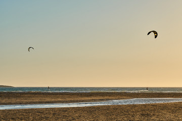 Kitesurfer riding at sunset