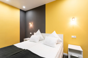 Hotel standart room. modern bedroom with white pillows. simple and stylish interior. interior lighting