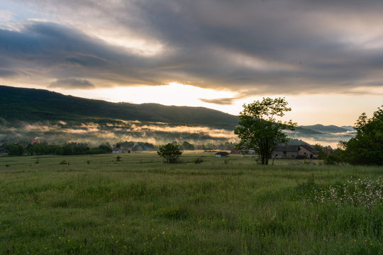 Landscape view during a misty sunrise over the  fields of Krasno polje mountain plateau near the Velebit mountain national park in Croatia. 