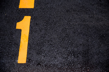 number 1 position paint on asphalt road background with copyspace