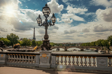 Fototapeta na wymiar Golden statue and lighting post adorning the Alexandre III bridge over the Seine River and Eiffel Tower in Paris. Known as one of the most impressive world’s cultural center. Retouched photo.
