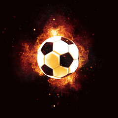 Flaming soccer ball and sparks on dark background