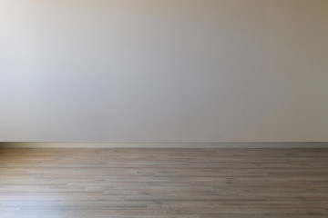 Empty room with gray wall and wooden floor