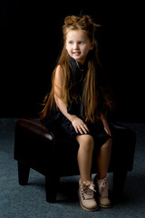 Obraz na płótnie Canvas Little girl on a black background