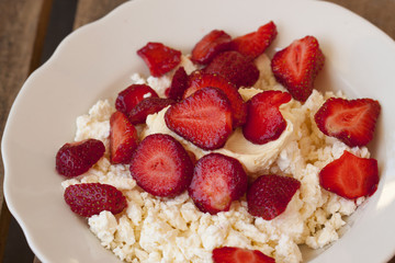 Dessert of fresh strawberries with cream and homemade cottage cheese