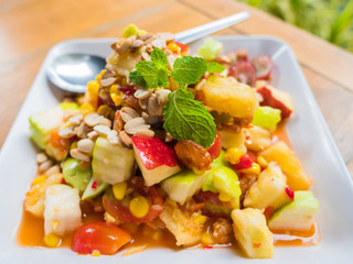 Top view of spicy thai fruits salad on wooden table