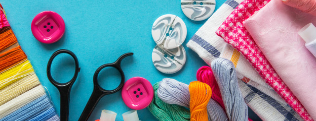 Sewing and objects for sewing. View from above. fabrics, tailor scissors, centimeter tape, thread,...