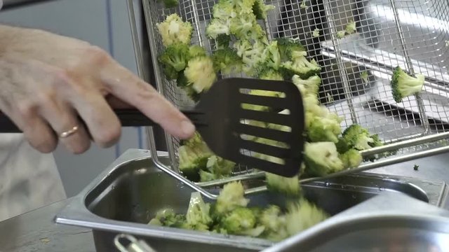 the chef puts cauliflower on a metal tray