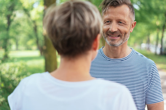 Smiling mature man looking at woman in park