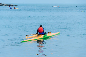 One girls at sea kayaks or canoe at tropical beach.