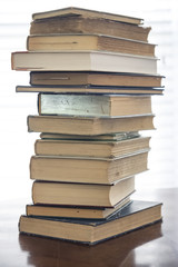 Stack of old books on kitchen table for study school in home or library