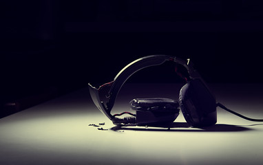 destroyed headphones on background.