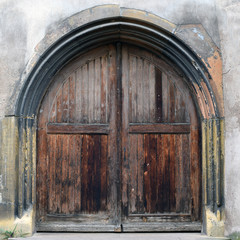 Massive old weathered wooden door.