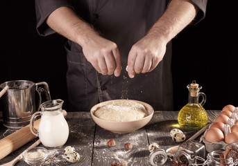 Baking ingredients, yeast dough in bowl, isolated on black