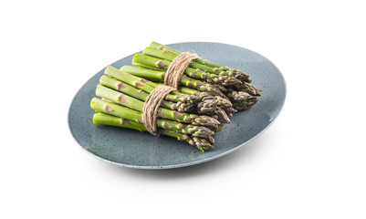 Fresh Asparagus on plate isolated on white background.