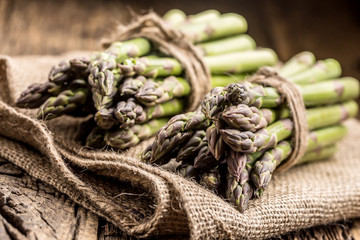 Bunch of fresh asparagus on rustic oak table
