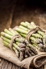 Bunch of fresh asparagus on rustic oak table