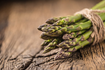 Bunch of fresh asparagus on rustic oak table