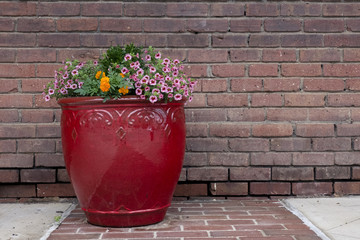 Community City Park bench on sidewalk or pathway beside decorative planter ready for someone to sit and enjoy a minute of rest or conversation