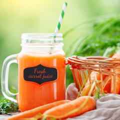 Fresh carrots and carrot juice in the garden. Harvest. Selective focus.