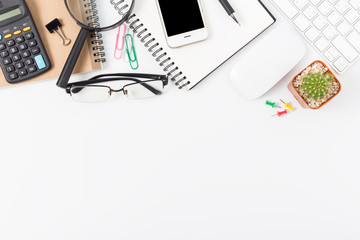 office desk with smartphone, computer and office supplies top view