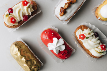 Assorted delicious sweets on grey background