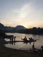 Fototapeta na wymiar Sunset at Riverside with mountain background , Travel in Vang Viang City, Laos. 5th December, 2013.