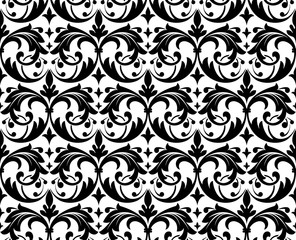 Wallpaper in the style of Baroque. A seamless vector background. White and black floral ornament. Graphic pattern for fabric, wallpaper, packaging. Ornate Damask flower ornament © ELENA