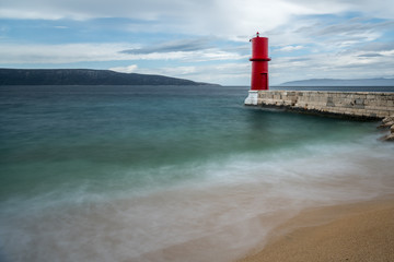 Obraz premium Red lighthouse of Cres on a cloudy day in spring