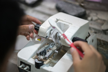 Eye glasses is cleaning by brushes after milling in workshop