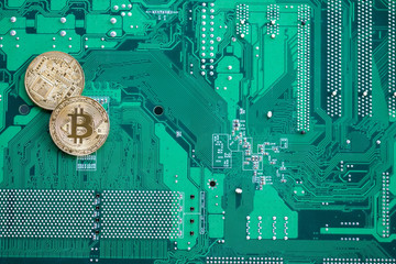 Bitcoin Coins on a Circuit Board Template. Green motherboard with bitcoins background for text....
