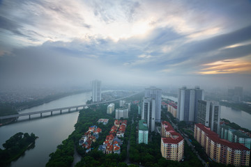Aerial skyline view of Hanoi cityscape at dawn with low clouds. Linh Dam peninsula, Hoang Mai district.