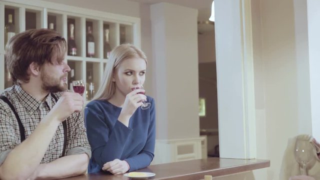 Attractive elegant young couple drinking a cocktail at the restaurant. Handsome loving couple flirting in a cafe. Love and romance. Lifestyle concept