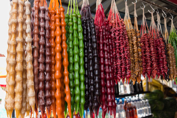 Fototapeta premium Churchkhela is Georgian traditional sweet dessert, candy cooked with grape juice, walnuts, hazelnut and flour.