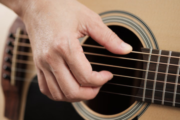 Fototapeta premium Close up woman's hands playing acoustic guitar.