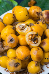 Fresh ripe mushmula or loquat fruit. Good for breakfast and desserts. Evergreen subtropical tree orange sweet and juicy fruit widely spread in Georgia, Japan, Korea, Spain and other asian countries.