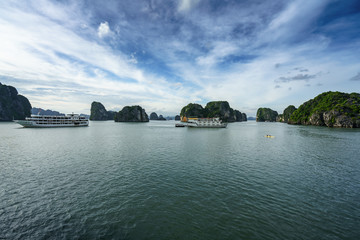 Halong bay with tourist junks and rocky islands. Popular landmark, famous destination of Vietnam
