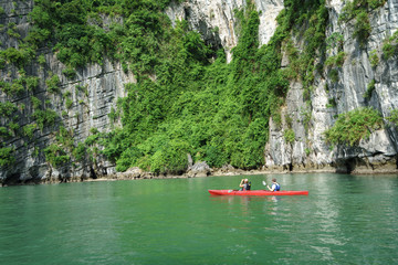 Naklejka na ściany i meble Halong bay in Vietnam, UNESCO World Heritage Site, with paddling kayak.