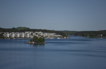 Naklejka premium Waterwiev of Stockhlm harbor a early moning in spring. Gåshaga and the small island Svanholmen in Lidingö, Stockholm, Sweden