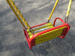 Old children swing seat on the playground. Missing child, abandoned kids playground