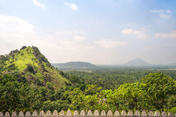 View from the Dambulla cave temple to the countryside with mountains, woodland and paddy fields 
