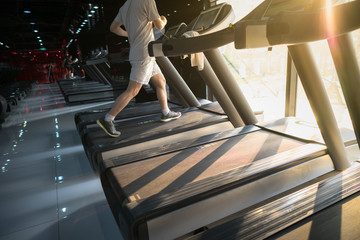 Machine treadmill with people running closeup at fitness gym