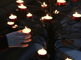child takes a candle in the church