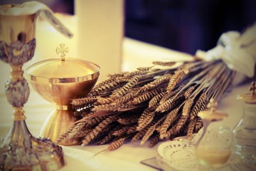 golden chalice and little bottle with wine on an altar in a chur