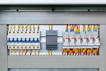 Several electrical circuit breakers, power supply and intermediate relays. Modern and reliable equipment in the electrical Cabinet. Connection of marked wires or cables.