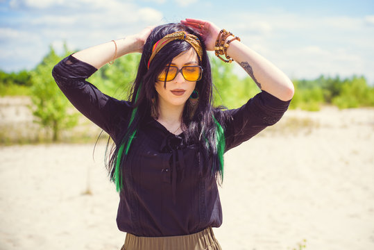 Beautiful woman with green hair posing in Indie or new Hippie style clothes . Outdoor fashion. Cute beautiful girl in boho style   